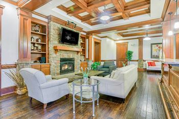 A living room with a fireplace and a flat screen tv.
